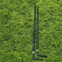 Two black metal stakes on a grassy surface