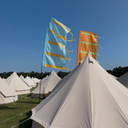 Outdoor event setup with festival flag adding height and movement