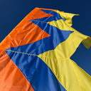 Vertical festival flag in bold colours set up outdoors