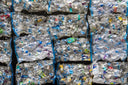 Stacks of recyled plastic bottles ready to be used to make recycled polyester