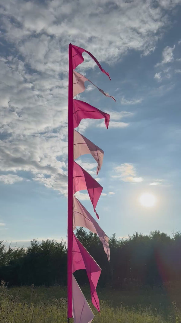 A pink flag at an outdoor event 