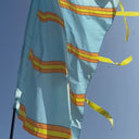 Close-up showing smooth satin sheen on festival flag